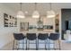 Open kitchen with an island, stainless steel appliances, and modern lighting features at 21595 S 225Th Way, Queen Creek, AZ 85142