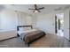 Bright main bedroom features a ceiling fan, carpet flooring, and ample natural light at 21595 S 225Th Way, Queen Creek, AZ 85142