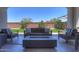 Outdoor patio featuring a fire pit, stylish furniture, and view of the landscaped backyard at 21595 S 225Th Way, Queen Creek, AZ 85142