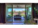 Covered patio with comfortable seating, ceiling fan, and a view of the manicured backyard at 21595 S 225Th Way, Queen Creek, AZ 85142