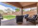 Outdoor living space features comfortable seating under a covered patio, perfect for relaxation and enjoying the backyard view at 21950 N Dietz Dr, Maricopa, AZ 85138