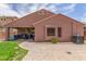 This backyard has a grass area, covered patio, and a brick paver patio for entertaining at 21950 N Dietz Dr, Maricopa, AZ 85138