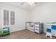 Bedroom features tile floors, neutral walls, window with blinds, and small bed at 21950 N Dietz Dr, Maricopa, AZ 85138