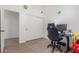 This bedroom offers ample closet space, wood-look tile floors, and room for a workspace at 21950 N Dietz Dr, Maricopa, AZ 85138
