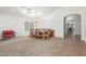 Bright dining room with large table, chairs, chandelier, carpet and tile flooring at 21950 N Dietz Dr, Maricopa, AZ 85138