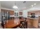 Well-lit eat-in kitchen with stainless steel appliances and wooden cabinets, with a view of dining table and appliances at 21950 N Dietz Dr, Maricopa, AZ 85138