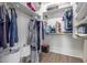 Spacious walk-in closet with shelves, hanging rods, and wood-look tile floor at 21950 N Dietz Dr, Maricopa, AZ 85138