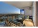 Relaxing covered balcony with comfortable seating and a modern fire pit overlooking city views at 2211 E Camelback Rd # 1203, Phoenix, AZ 85016