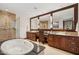 Primary bathroom featuring double vanity, large mirror, and separate bathtub and shower at 2211 E Camelback Rd # 1203, Phoenix, AZ 85016