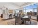 A dining area with bar stool seating, table and chairs, and cityscape view at 2211 E Camelback Rd # 1203, Phoenix, AZ 85016