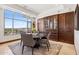 Bright dining area with natural light, table, chairs, and custom cabinetry at 2211 E Camelback Rd # 1203, Phoenix, AZ 85016