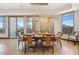 Elegant dining room featuring a modern chandelier, neutral colors, and balcony view at 2211 E Camelback Rd # 1203, Phoenix, AZ 85016