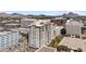 Multi-story building featuring multiple windows and balconies surrounded by lush landscaping at 2211 E Camelback Rd # 1203, Phoenix, AZ 85016