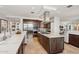 This is a kitchen featuring custom cabinetry and a large center island with granite countertop at 2211 E Camelback Rd # 1203, Phoenix, AZ 85016