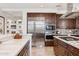 Modern kitchen boasting stainless steel refrigerator, oven and center island cooktop at 2211 E Camelback Rd # 1203, Phoenix, AZ 85016