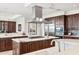 Spacious kitchen featuring a large center island, bar seating, and luxury appliances at 2211 E Camelback Rd # 1203, Phoenix, AZ 85016