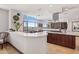 Gourmet kitchen featuring a center island, stainless steel appliances, bar seating and city view at 2211 E Camelback Rd # 1203, Phoenix, AZ 85016