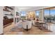 Bright living room featuring art, comfortable seating, travertine floors, and large windows with mountain views at 2211 E Camelback Rd # 1203, Phoenix, AZ 85016