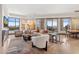 Bright living room featuring contemporary furnishings, eye-catching artwork, and expansive windows showcasing scenic views at 2211 E Camelback Rd # 1203, Phoenix, AZ 85016