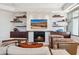 Cozy living room featuring built-in shelving, a modern fireplace, and comfortable seating at 2211 E Camelback Rd # 1203, Phoenix, AZ 85016