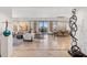 Expansive living room featuring art, sleek furnishings, travertine floors, and large windows with city views at 2211 E Camelback Rd # 1203, Phoenix, AZ 85016