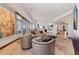Open living room with views, comfortable seating, travertine floors and contemporary artwork at 2211 E Camelback Rd # 1203, Phoenix, AZ 85016