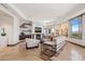 Inviting living room featuring a modern fireplace, media shelving, and large windows with scenic views at 2211 E Camelback Rd # 1203, Phoenix, AZ 85016