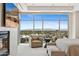 Relaxing main bedroom featuring a fireplace and floor-to-ceiling windows overlooking the city at 2211 E Camelback Rd # 1203, Phoenix, AZ 85016