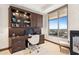 This office has custom built-ins, large windows, and a neutral color scheme at 2211 E Camelback Rd # 1203, Phoenix, AZ 85016