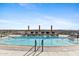 Rooftop pool deck with lounge chairs, umbrellas, and panoramic city views at 2211 E Camelback Rd # 1203, Phoenix, AZ 85016