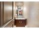 Stylish powder room featuring a unique vanity, marble countertop, and modern lighting at 2211 E Camelback Rd # 1203, Phoenix, AZ 85016