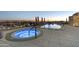 Luxury rooftop deck featuring a hot tub and pool with views of the city skyline at dusk at 2211 E Camelback Rd # 1203, Phoenix, AZ 85016
