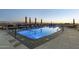Stunning rooftop pool with lounge chairs and city views at sunset at 2211 E Camelback Rd # 1203, Phoenix, AZ 85016