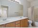 Bathroom featuring a double sink vanity with a large mirror and a shower-tub combo at 22231 N 51St St, Phoenix, AZ 85054