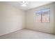 Neutral bedroom featuring light walls, neutral carpet, one window, and a ceiling fan at 22231 N 51St St, Phoenix, AZ 85054