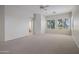 Spacious carpeted bedroom with bright windows and access to the ensuite bathroom at 22231 N 51St St, Phoenix, AZ 85054
