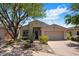 Beautiful home with desert landscaping, mature trees, and a convenient two-car garage at 22231 N 51St St, Phoenix, AZ 85054