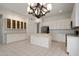 Bright kitchen features white cabinets, a center island with tile countertop, and stainless steel appliances at 22231 N 51St St, Phoenix, AZ 85054
