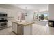 Kitchen featuring white cabinets, a tiled island, stainless steel appliances, and seamless access to living areas at 22231 N 51St St, Phoenix, AZ 85054