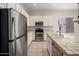 Bright kitchen featuring stainless steel appliances, tiled countertops, and ample cabinet space at 22231 N 51St St, Phoenix, AZ 85054