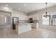 Bright kitchen featuring a tile counter island, stainless steel refrigerator and pendant lighting fixture at 22231 N 51St St, Phoenix, AZ 85054