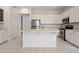 Bright kitchen featuring a large island with a sink, stainless appliances, and white cabinetry at 22231 N 51St St, Phoenix, AZ 85054