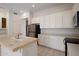 Well-lit kitchen with an island sink, stainless steel appliances, and bright white cabinets at 22231 N 51St St, Phoenix, AZ 85054