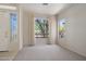 Welcoming living room featuring large windows with bright natural light and tiled flooring at entry at 22231 N 51St St, Phoenix, AZ 85054