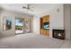 Inviting living room featuring a fireplace, built-in shelving, and sliding glass doors to the outdoors at 22231 N 51St St, Phoenix, AZ 85054