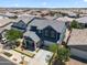 Aerial view of a suburban home with gray shingles, manicured lawns, and desert landscaping at 23451 S 228Th St, Queen Creek, AZ 85142