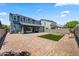 Back exterior view of a two-story home with a putting green and pavers at 23451 S 228Th St, Queen Creek, AZ 85142