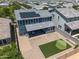 Aerial view of a blue two-story house featuring a backyard putting green and solar panels at 23451 S 228Th St, Queen Creek, AZ 85142