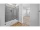 Modern bathroom showcasing a glass-enclosed shower with gray tiling and laminate flooring at 23451 S 228Th St, Queen Creek, AZ 85142