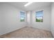 Bedroom featuring neutral walls, plush carpeting, and two windows offering natural light at 23451 S 228Th St, Queen Creek, AZ 85142
